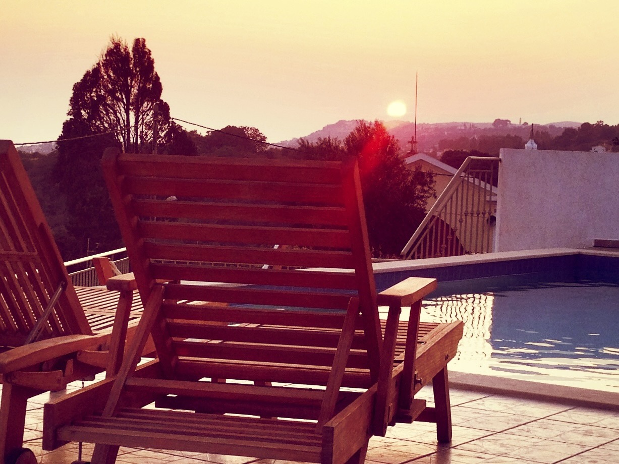 Sunset over the hills from the sun loungers on the pool terrace
