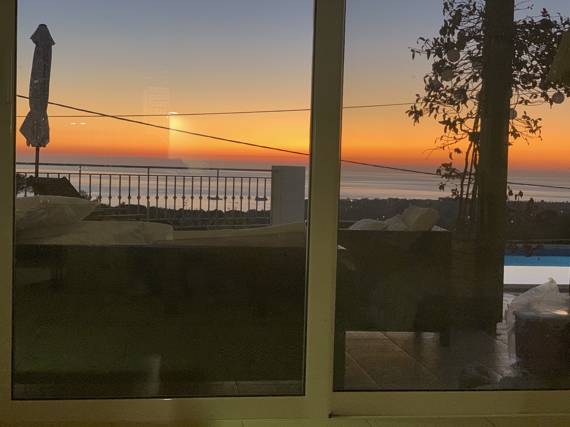 Sunset over the Ionian sea seen through the villa windows